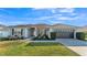Charming single-story home with a well-manicured lawn, updated two car garage, and tidy landscaping at 1570 Doves View Cir, Auburndale, FL 33823