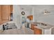 Kitchen features wood cabinets, stainless steel appliances, and tile floor at 1570 Doves View Cir, Auburndale, FL 33823