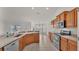 Open kitchen with stainless steel appliances and wood cabinets at 1570 Doves View Cir, Auburndale, FL 33823