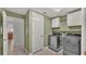 Laundry room with washer, dryer, cabinets and access to kitchen at 1570 Doves View Cir, Auburndale, FL 33823