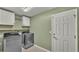 Laundry room with washer, dryer, and cabinets at 1570 Doves View Cir, Auburndale, FL 33823