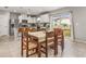 Dining area with wooden table and chairs, adjacent to kitchen at 1576 Aspen Ave, Davenport, FL 33837