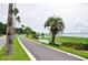 Scenic paved path alongside a lake with palm trees at 1600 W Lake Parker Dr # B7, Lakeland, FL 33805
