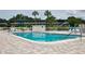 Community pool with surrounding patio and building in the background at 1600 W Lake Parker Dr # B7, Lakeland, FL 33805