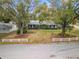 Aerial view of a single story house with a large front yard at 1628 Lakewood S Dr, Lakeland, FL 33813