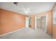 Bedroom with ceiling fan and mirrored closet doors at 1628 Lakewood S Dr, Lakeland, FL 33813