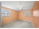 Bedroom with ceiling fan and peach colored walls at 1628 Lakewood S Dr, Lakeland, FL 33813