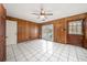 Bonus room with wood paneling, tiled floors, and French doors at 1628 Lakewood S Dr, Lakeland, FL 33813