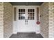 Front entry with white double doors and brick facade at 1628 Lakewood S Dr, Lakeland, FL 33813