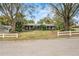Ranch style home with mature landscaping and white picket fence at 1628 Lakewood S Dr, Lakeland, FL 33813