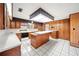 Kitchen with wood cabinets, island, and white countertops at 1628 Lakewood S Dr, Lakeland, FL 33813