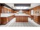 Kitchen boasts wood cabinets, an island, and white countertops at 1628 Lakewood S Dr, Lakeland, FL 33813