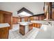 Kitchen with island, stainless steel dishwasher, and wood cabinets at 1628 Lakewood S Dr, Lakeland, FL 33813