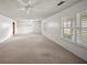 Bright and airy living room with multiple windows and ceiling fan at 1628 Lakewood S Dr, Lakeland, FL 33813