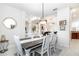 Bright dining room with a grey wash table and white chairs, view to living room at 1695 Doves View Cir, Auburndale, FL 33823