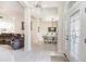 Foyer with marble tile, chandelier and views of living and dining areas at 1695 Doves View Cir, Auburndale, FL 33823