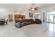 Spacious living room with leather sectional sofa and high ceilings at 1695 Doves View Cir, Auburndale, FL 33823