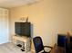 Bedroom with a workspace, TV, and large window at 1700 6Th Nw St # C27, Winter Haven, FL 33881