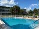 Inviting community pool with lounge chairs and patio tables at 1700 6Th Nw St # C27, Winter Haven, FL 33881