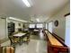 Community room with tables, chairs, shuffleboard, and pool table at 1700 6Th Nw St # C27, Winter Haven, FL 33881