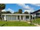 Building exterior featuring a white building with green accents and a manicured lawn at 1700 6Th Nw St # C27, Winter Haven, FL 33881