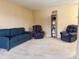 Living room featuring two armchairs and a bookshelf at 1700 6Th Nw St # C27, Winter Haven, FL 33881