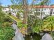 Apartment building with pond and lush greenery at 200 El Camino Dr # 309, Winter Haven, FL 33884