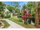 Landscaped backyard with pond and walkway at 200 El Camino Dr # 309, Winter Haven, FL 33884