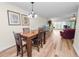 Bright dining area with wood table and hardwood floors at 200 El Camino Dr # 309, Winter Haven, FL 33884