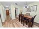 Dining room with wood table and chairs, and access to kitchen and hallway at 200 El Camino Dr # 309, Winter Haven, FL 33884