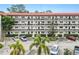 Two-story building with parking and tropical landscaping at 200 El Camino Dr # 309, Winter Haven, FL 33884