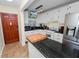 Kitchen with white cabinets, granite counters, and appliances at 200 El Camino Dr # 309, Winter Haven, FL 33884