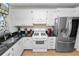 Modern kitchen featuring stainless steel appliances and white cabinetry at 200 El Camino Dr # 309, Winter Haven, FL 33884