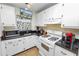 White kitchen with granite countertops and gas stove at 200 El Camino Dr # 309, Winter Haven, FL 33884