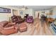 Living room features leather furniture and a view into dining area at 200 El Camino Dr # 309, Winter Haven, FL 33884
