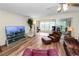 Spacious living room with leather furniture and wood-look floors at 200 El Camino Dr # 309, Winter Haven, FL 33884