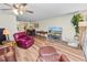 Open living room with hardwood floors and ample seating at 200 El Camino Dr # 309, Winter Haven, FL 33884