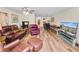Bright living room with hardwood floors and a view into dining area at 200 El Camino Dr # 309, Winter Haven, FL 33884