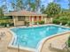 Community pool with lounge chairs at 200 El Camino Dr # 309, Winter Haven, FL 33884