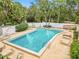 Inviting kidney-shaped pool with surrounding chairs at 200 El Camino Dr # 309, Winter Haven, FL 33884