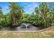 Relaxing pond and fountain, surrounded by palms at 200 El Camino Dr # 309, Winter Haven, FL 33884