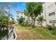 Building and canal view with lush landscaping at 200 El Camino Dr # 309, Winter Haven, FL 33884