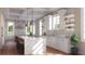 Spacious modern kitchen featuring marble countertops, white cabinetry, stylish lighting, and a functional island with seating at 23 Lake Hollingworth, Lakeland, FL 33803