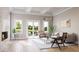 Bright living room boasts contemporary furnishings, elegant decor, a cozy fireplace, and seamless access to the outdoor patio at 23 Lake Hollingworth, Lakeland, FL 33803