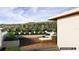 Relaxing rooftop patio featuring a comfortable lounge area and green shrubbery overlooking a serene lake view at 23 Lake Hollingworth, Lakeland, FL 33803