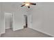 Carpeted bedroom has a ceiling fan and access to a closet and other rooms at 2424 Delphi Cir, Lakeland, FL 33812