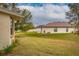 Spacious backyard with grassy area and partial view of neighboring home at 2507 Torrens Dr, Lakeland, FL 33805