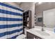 Bathroom with a blue and white striped shower curtain at 2507 Torrens Dr, Lakeland, FL 33805