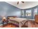 Bedroom with wood floors, a bed, nightstand, and large windows at 2507 Torrens Dr, Lakeland, FL 33805