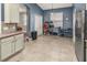 Bright kitchen with blue walls, white cabinets, and tiled floors at 2507 Torrens Dr, Lakeland, FL 33805